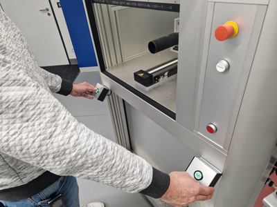 Laser marking system that can only be activated by simultaneous two-hand operation